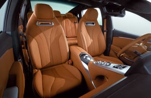 Der Blick auf das GWM ORA 07 Cockpit mit Frontscheibe, 3-Speichen-Lenkrad, zwei Touchscreens, Mittelkonsole, Außenspiegeln und Panorama-Glasdach im braun-schwarzen Interieur